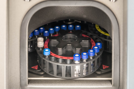 Runder Probenhalter mit mehreren kleinen Glasfläschchen in einem HPLC-Autosampler.